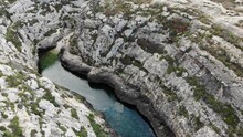 Malta, Gozo Island Ghasri Valley Mediterranean Sea Canyon, Aerial View Of Rocky Cliff And Hidden Beach