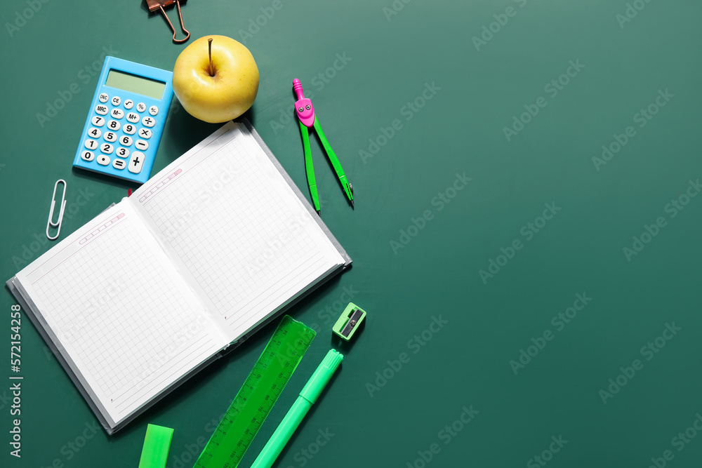 Set of stationery with blank open notebook on green blackboard. Pi Day celebration