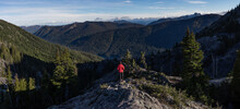 Young hiker girl gazes out on wild expanse in Alpine Lakes Wilderness