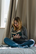 © Cavan Images - Young woman reads a book in her room