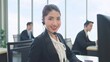 © M Stocker - Smilling face of asian woman customer support agent or call center wearing headphone and works on desktop computer at office