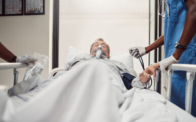 Hospital, senior patient and doctors for emergency on a bed with oxygen mask for healthcare. Sick old man with health problem and medical team er or surgery in theater for life insurance and help