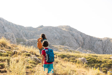 mother with a child on a hike walk along the road