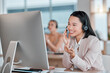 © Lumeez/peopleimages.com - Asian woman, call center and computer with smile for telemarketing, customer support or service at office desk. Happy female consultant agent smiling in contact us for desktop advice, help or sales