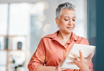 Canvas Print - Digital tablet, senior woman and working business employee reading app data in a agency. Mature worker, online planning and female with focus and mockup on a internet connection networking on the web