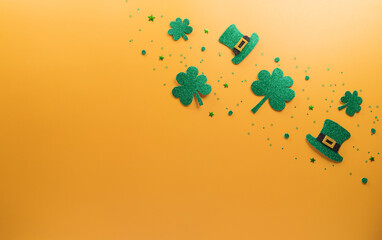 Wall Mural - Happy St Patrick's Day decoration concept made from shamrocks ( clover leaf), wooden calendar and leprechaun hat on yellow background.