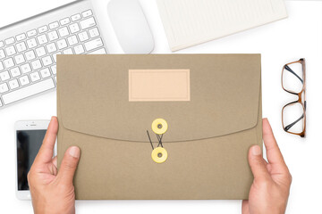 Man's hand holding a paper folder or important information for job application or presentation to the organization