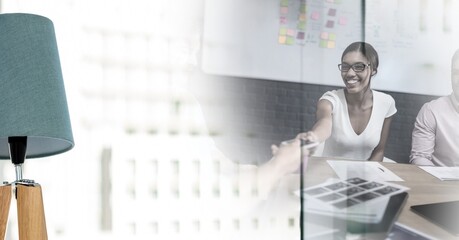 Poster - Composition of two happy diverse businesspeople shaking hands with motion blur