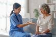 © NanSan - Young asian caretaker with 60s asia elderly woman consulting and encourage, take a history and recommend the right treatment, recommend taking painkillers and cure cancer