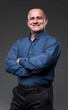 © Xalanx - Smiling confident businessman with arms folded