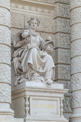 Wall Mural - Vienna, Austria - Sculpture of powerful woman with hammer and severed head known as Bildhauerei located museums district, downtown in Vienna, Austria