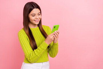 Wall Mural - Photo of adorable girl toothy smile use smart phone typing write empty space isolated on pink color background