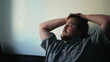© Marco - One pensive overweight young man thinking deeply at home. Thoughtful male caucasian person looking out window with meditative expression