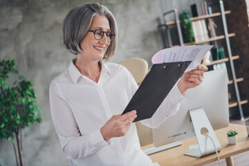 Sticker - Portrait of positive successful lawyer lady hold read clipboard annual report document workstation indoors