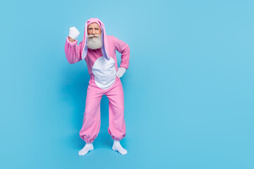 Poster - Full length photo of aggressive angry man pensioner dressed pink rabbit nightwear showing fist empty space isolated blue color background