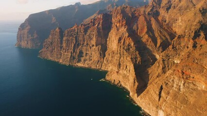 Wall Mural - Beautiful mountain sunset cliffs Los Gigantes Tenerife island with amazing aerial view of deep ocean blue water and barren huge rocks. The Giants. Travel the World. Vibrant colors.