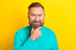 Photo of pensive ponder concentrated focused man wear trendy clothes solve task isolated on yellow color background