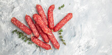 Small Dty Salami Sausages On A Light Background. Long Banner Format. Top View