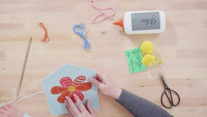 Wall Mural - Flat lay. Little girl learning how to sew with her mother at the craft table.