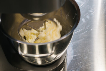 Wall Mural - Making macarons. A silver kitchen table mixer kneads the dough for macarons.