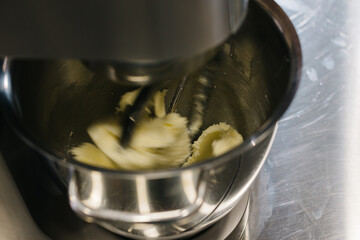 Wall Mural - Making macarons. A silver kitchen table mixer kneads the dough for macarons.