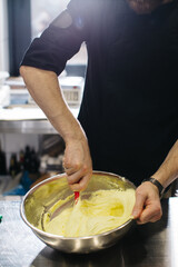 Wall Mural - The chef works in the kitchen. The process of making dough for macaroons.