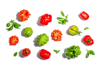 Green and red ribbed tomatoes isolated on white background. American or Florentine variety