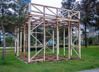 Metal construction. Metal frame trade tent. Abandoned structure in the park.