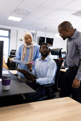 Wall Mural - Vertical image of female and male diverse businesspeople working in office