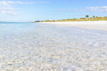 Wall Mural - Crystal clear transparent blue water of Gulf of Mexico at Barefoot Beach, Southwest Florida near Bonita Springs and blurry background on sunny day