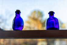 Kitchen Window Blue Medicine Herbal Elixir Bottle Decorations Decor With Empty Glass In Sunlight Closeup On Shelf With Cozy Atmoshpere