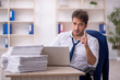 © Elnur - Young male employee and too much work in the office