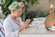 © Hector Pertuz - Women making necklaces on rustic wooden table
