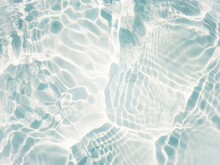 Defocus Blurred Transparent Blue Colored Clear Calm Water Surface Texture With Splashes And Bubbles. Trendy Abstract Nature Background. Water Waves In Sunlight With Copy Space. Blue Water Shine