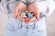 © New Africa - Woman holding pile of antidepressants, closeup view