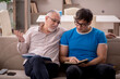 © Elnur - Young male student and his grandfather at home