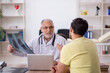 © Elnur - Young male doctor visiting old male doctor radiologist