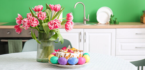 Wall Mural - Vase with tulips, Easter cake and colorful eggs on dining table in kitchen