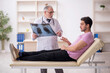 © Elnur - Young male patient visiting old male doctor radiologist