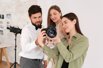 Poster - Female photographer working with couple in studio