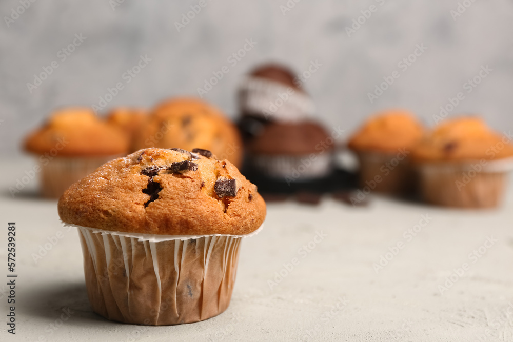 Delicious muffin with chocolate chips on table
