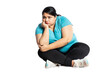 Sad overweight indian woman sitting on floor isolated over white background, Depressed fat girl thinking to loose weight. Mental health, Copy space.