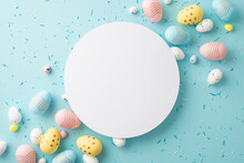 Easter Decor Concept. Top View Photo Of Ordered Composition White Circle Yellow Blue Pink Easter Eggs And Sprinkles On Isolated Pastel Blue Background With Empty Space