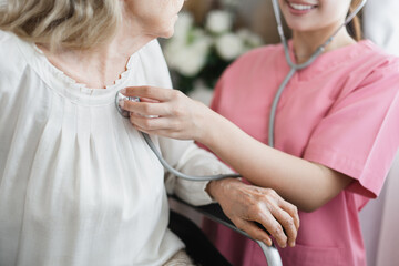 Wall Mural - Hand hold stethoscope listen to elderly patient woman heart 