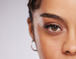 © Nina Lawrenson/peopleimages.com - Eye, vision and beauty with contact lens and black woman, care for eyes and cosmetics with closeup on studio background. Microblading, eyebrow and lashes, face and skin in portrait with mockup space