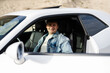 © AS Photo Family - Handsome man in jeans jacket and cap sit at his white muscle car.