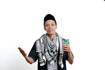 Religious muslim asian man wearing turban, muslim dress and cap. Holding smartphone while smiling. isolated on white background.