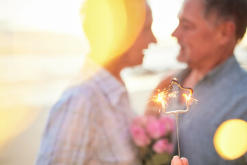 Canvas Print - Couple, sparkler and date to celebrate love, birthday and vacation or holiday at beach in summer. Senior man and woman hug outdoor with star and bokeh for sunset dating, marriage or valentines day