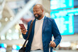 © Nina Lawrenson/peopleimages.com - Black man in airport with passport, ticket and smile, travelling to foreign country for business trip. Visa, travel and happy businessman waiting for flight time to international destination for work