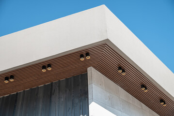 PVC ceiling panel covered with wood-like vinyl with modern lighting installed on it